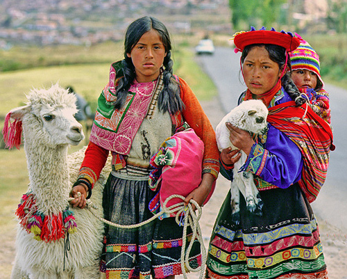 Two Peruvian girls with a llama
